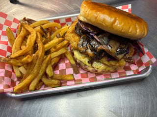 Gourmet burger with caramelized onions and cheese on a toasted bun